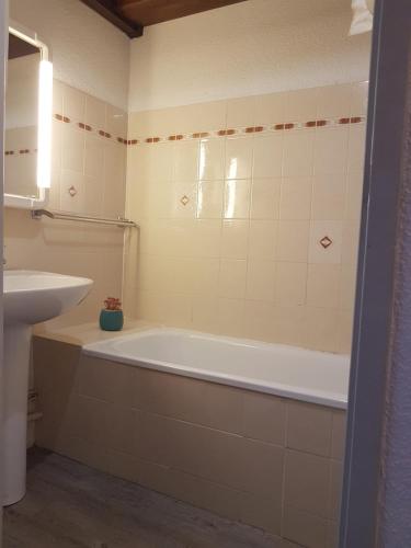 une salle de bain avec une baignoire et un lavabo dans l'établissement Font-Romeu Appart T2 + Cabine - Vue panoramique, à Font-Romeu-Odeillo-Via