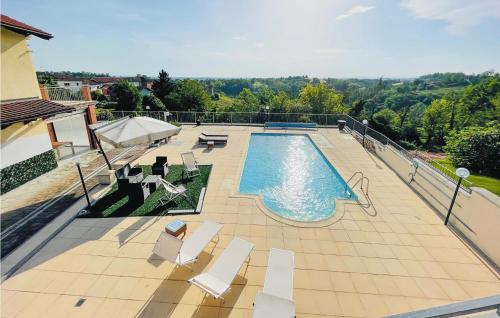 a swimming pool with white chairs at Amazing Home In Montegrosso Cinaglio in Monale