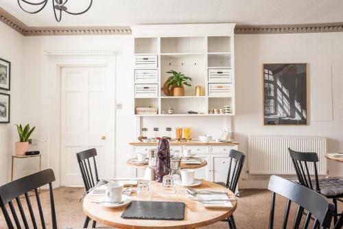 a dining room with a wooden table and chairs at Lyme Townhouse in Lyme Regis
