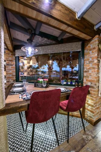 a dining room with a table and two chairs at Traditional Guesthouse in Tríkala