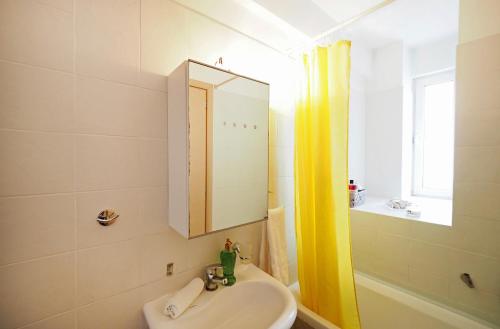 a bathroom with a sink and a mirror at Cozy Apartment St John in Chalkida