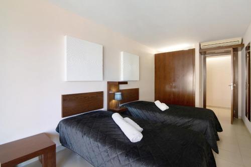 Ένα ή περισσότερα κρεβάτια σε δωμάτιο στο Apartamento Salgados Sol e Sal