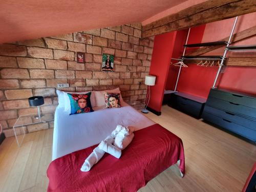 a bedroom with a bed with a teddy bear on it at Duplex Revellín Frida Home AIRE ac in Logroño