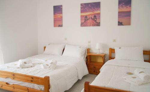 a bedroom with two beds with towels on them at Mak Luxury Rooms in Parga