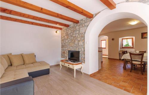a living room with a couch and a fireplace at 2 Bedroom Beautiful Home In Barci in Barci