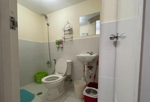 a small bathroom with a toilet and a sink at Urban Deca Homes Manila Rustic Cozy Staycation in Manila