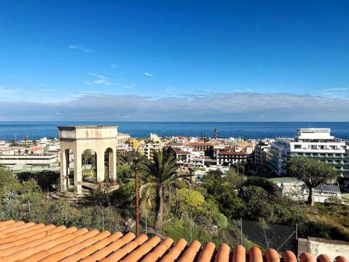 a view of a city from a roof of a building at lujosa villa con piscina privada in Puerto de la Cruz