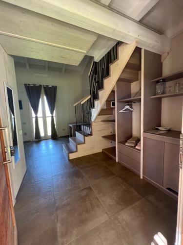 a room with a staircase and a floor at ALELCA DOMO in Buggerru