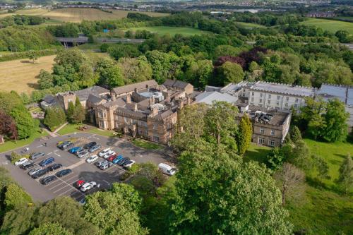 an aerial view of a building with a parking lot at Mercure Blackburn Dunkenhalgh Hotel & Spa in Blackburn