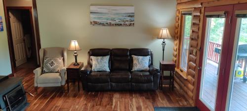 a living room with a couch and a chair at Tobermory Peaceful Private Entire Cottage Log Home Spacious Fully Equipped in Miller Lake