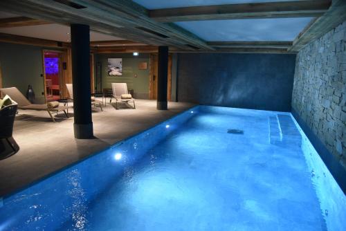 a large swimming pool in a house at Hotel MONT-BLANC VAL D'ISERE in Val dʼIsère
