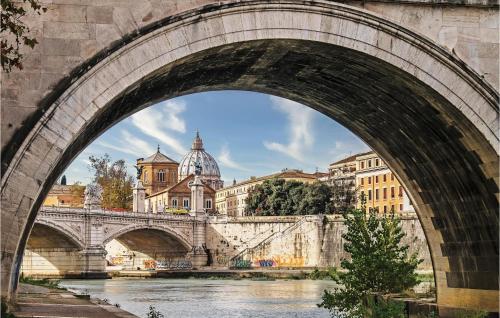 a bridge over a river with buildings behind it at 5 Bedroom Amazing Home In Grottaferrata in Grottaferrata