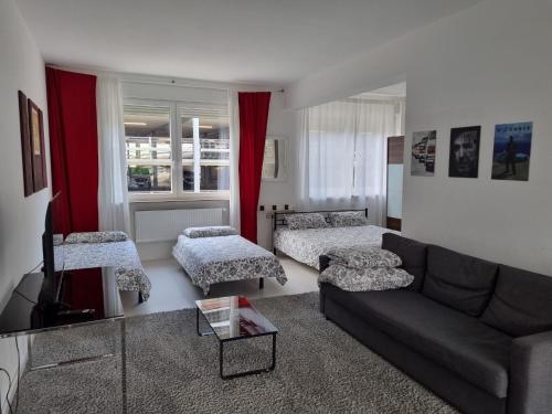 a living room with a couch and two chairs at Schönes modernes Loft in Essen - Südviertel in Essen