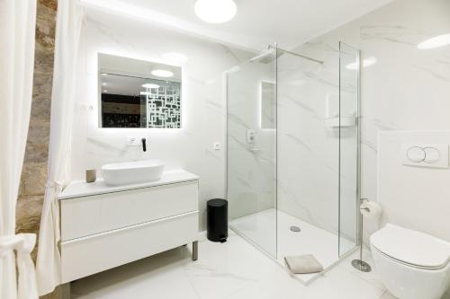 a white bathroom with a sink and a shower at Palace luxury room in Split