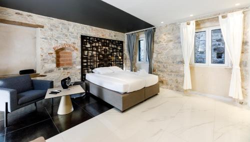 a bedroom with a bed and a chair and a couch at Palace luxury room in Split