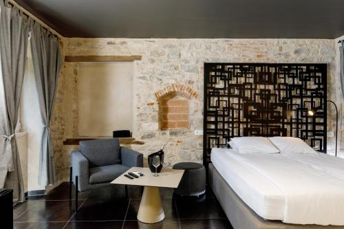 a bedroom with a bed and a chair and a table at Palace luxury room in Split