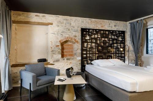 a bedroom with a bed and a chair and a table at Palace luxury room in Split