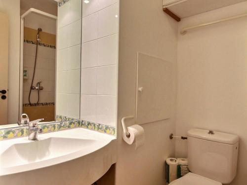 a bathroom with a sink and a toilet and a mirror at Appartement 3 pièces avec balcon et 2 salles de bains, 6 personnes, Plagne Soleil - FR-1-455-48 in Plagne Villages