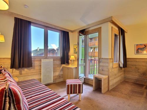 une chambre avec un lit et une grande fenêtre dans l'établissement Appartement spacieux 4 pers, balcon, proche pistes - FR-1-455-176, à La Plagne Tarentaise