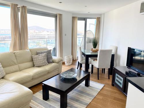 a living room with a couch and a table at Ocean Village Lovely 2 bedroom apartment in Gibraltar
