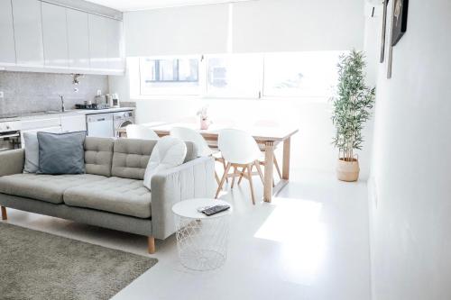 a living room with a couch and a table at Rest House - Vila do Conde in Vila do Conde