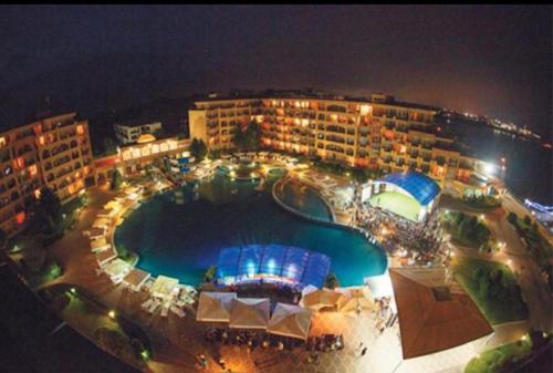 an overhead view of a pool at a resort at night at Midia Grand Resort in Aheloy