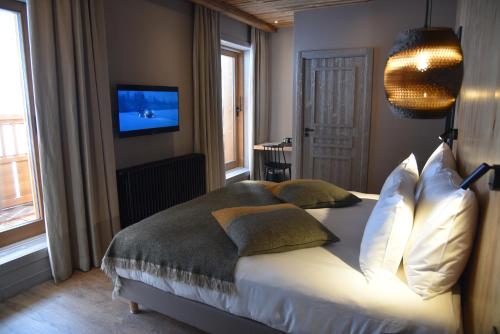 Ένα ή περισσότερα κρεβάτια σε δωμάτιο στο Hotel MONT-BLANC VAL D'ISERE