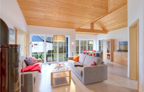 a living room with two couches and a table at Ferienhaus 28 Altefähr in Altefähr
