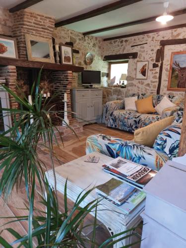 a living room with a couch and a table at Lazy Days in Rancon