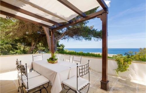 una mesa y sillas en un patio con vistas al océano en Panoramica, en Lido Conchiglia