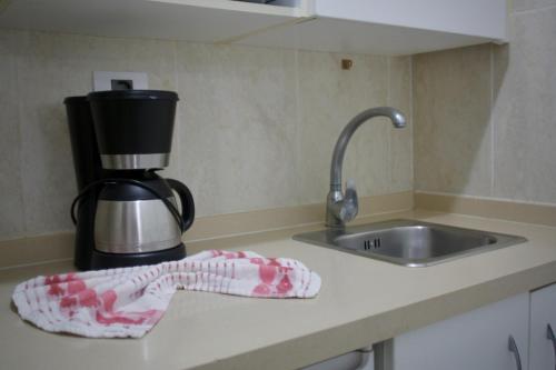 a kitchen counter with a sink and a sock on the counter at Hotel Tropical in Puerto de la Cruz