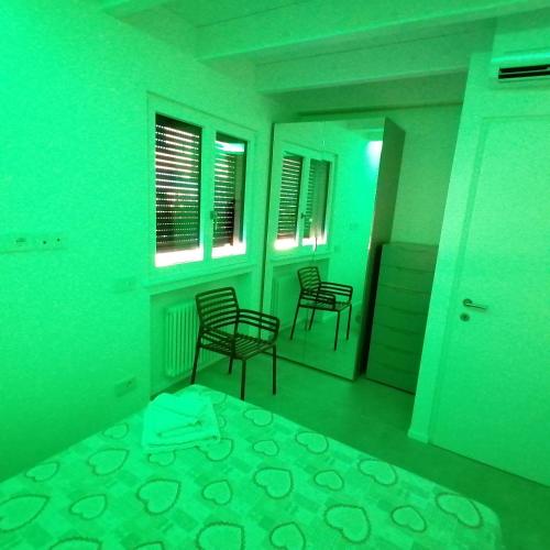 two chairs in a room with green lights at New Marina Apartments in Torri del Benaco