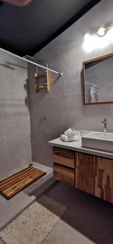 a bathroom with a sink and a mirror at HBG Glamping community Yoga & Wellness space in Santa Teresa Beach