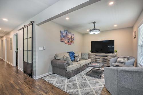 a living room with couches and a flat screen tv at World Cup Base Less Than 3 Mi to Mercedes-Benz Stadium! in Atlanta