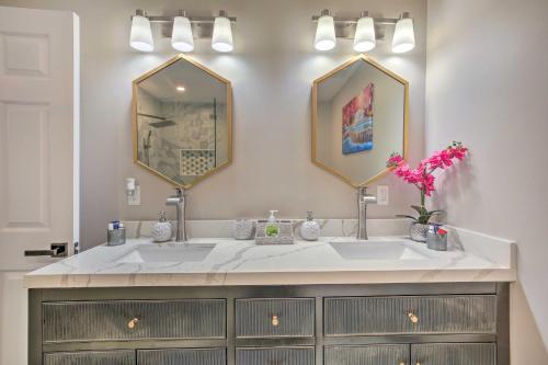 a bathroom with two sinks and two mirrors at World Cup Base Less Than 3 Mi to Mercedes-Benz Stadium! in Atlanta