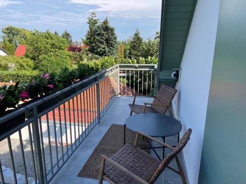 a balcony with two chairs and a table at Buborék in Csopak