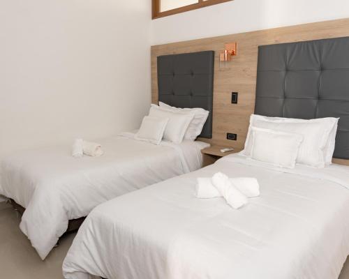 Una cama o camas en una habitación de Primavera Plus