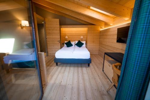 a small room with a bed in a cabin at Alpi & Golf Hotel in Bormio