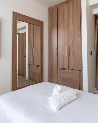 Una cama o camas en una habitación de Primavera Plus