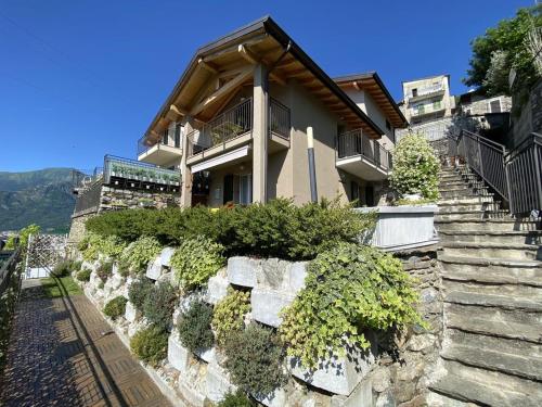 a house with stairs leading up to it at La Rondine in Gravedona