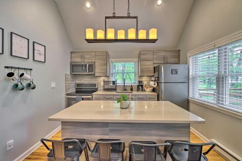 a kitchen with a large island with chairs in it at Near Lakes and Resorts Pet-Friendly Long Pond Abode in Long Pond