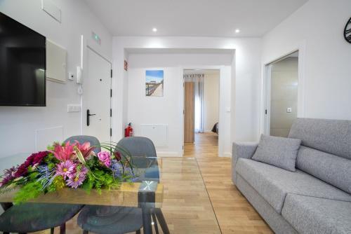 a living room with a table and a couch at Apartamentos La Jasa in Arguedas