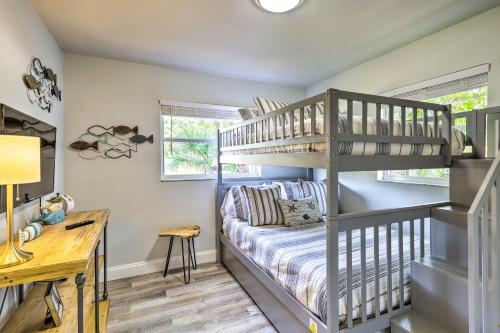 a room with a bunk bed and a desk at Merritt Island Oasis with Pool about 7 Mi to Beach! in Merritt Island