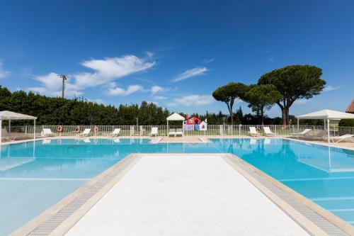 a large swimming pool with blue water at Fattoria San Lorenzo in Grosseto