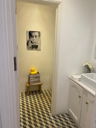 a bathroom with a black and white checkered floor at City center boutique apartment in Funchal