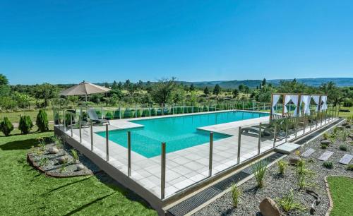 an image of a swimming pool at a resort at Sierras Encantadas Cabañas in Panaholma