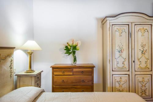 a bedroom with a bed and a dresser and a dresser at Fattoria San Lorenzo in Grosseto