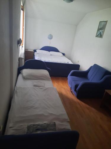 a room with two beds and a couch at Motel Tetrijeb Sipovo in Šipovo