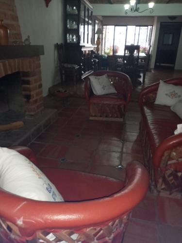 a living room with a couch and a fireplace at Casa Tapalpa in Tapalpa