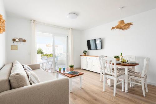 a living room with a couch and a table at Apartamento CASTELLSOL 309 by Mauter Villas in Arenal d'en Castell